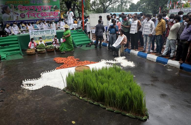 Supporters of All India Trinamool Congress party stand around agricultural products arranged in a formation of a map of India as part of protests against farm bills passed by India's parliament, in Kolkata, India, September 25, 2020. REUTERS/Rupak De Chowdhuri